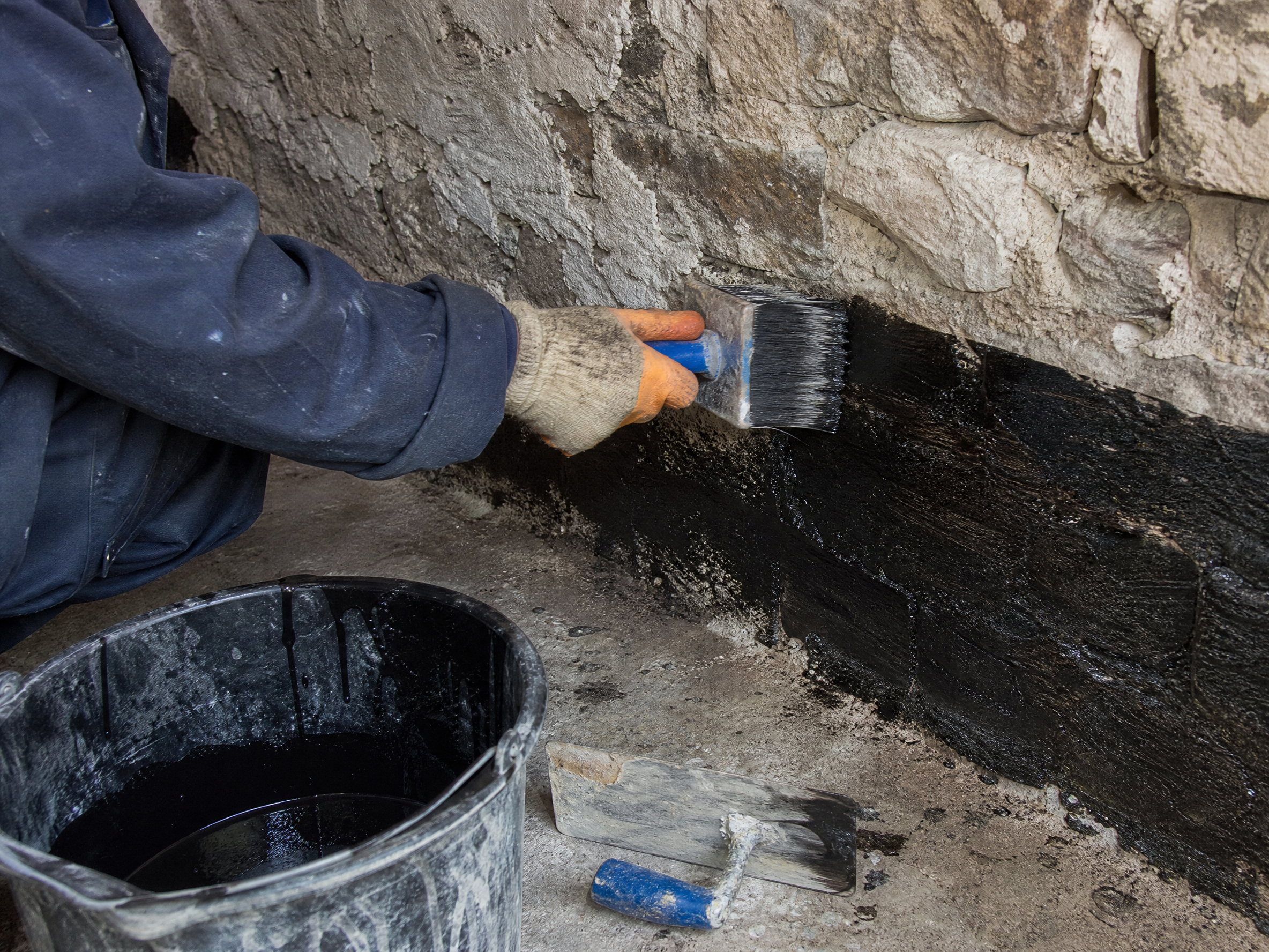 Professional installer carrying out cellar tanking in a UK residential property
