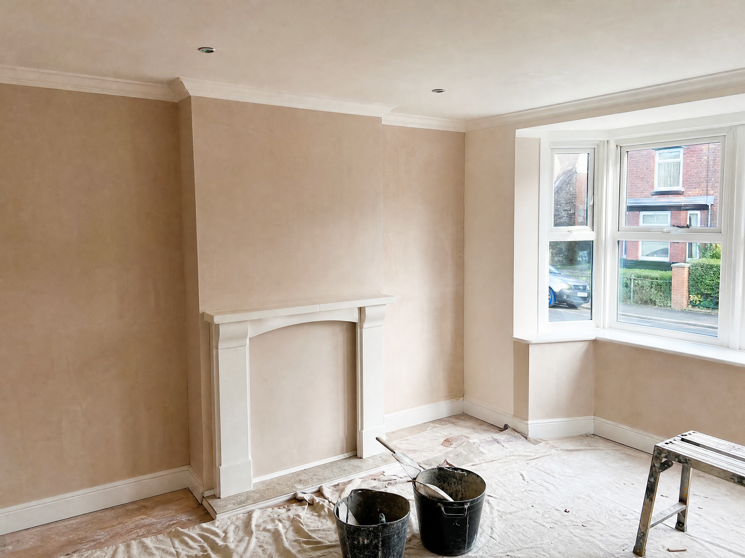 Completed replastering after damp treatment showing professional quality workmanship in a British home